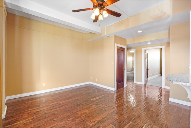 spare room featuring wood-type flooring and ceiling fan