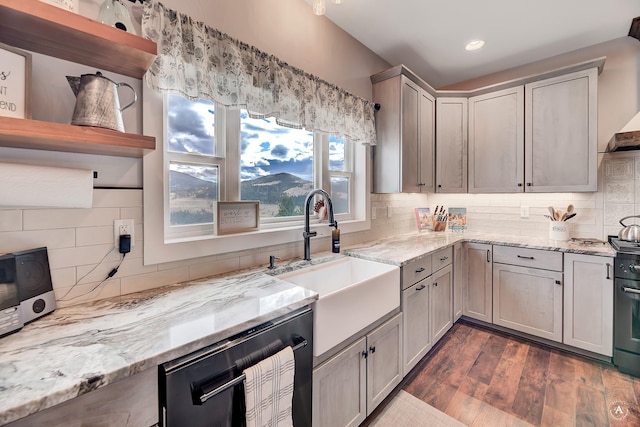 kitchen featuring gray cabinetry, backsplash, dark wood-type flooring, sink, and light stone counters