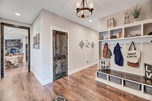 mudroom with hardwood / wood-style flooring and a chandelier