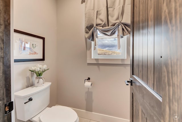 bathroom featuring tile patterned flooring and toilet