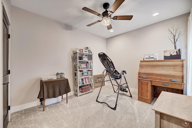 carpeted office space with ceiling fan