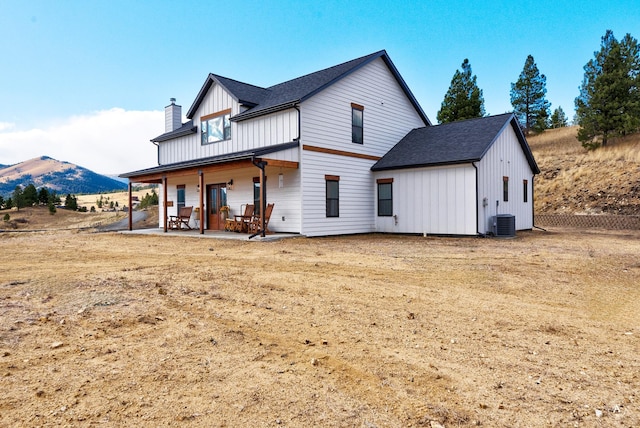 back of property with a mountain view, a patio area, and central air condition unit