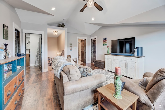 living room with ceiling fan, dark hardwood / wood-style flooring, and lofted ceiling