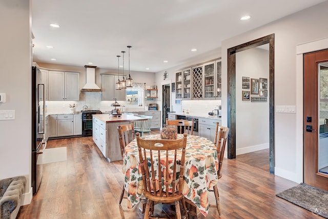 dining area featuring wood-type flooring and wine cooler