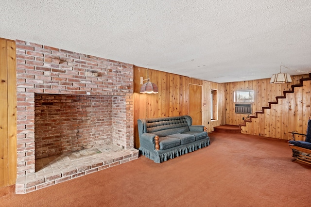 unfurnished living room featuring wooden walls, carpet floors, and a textured ceiling