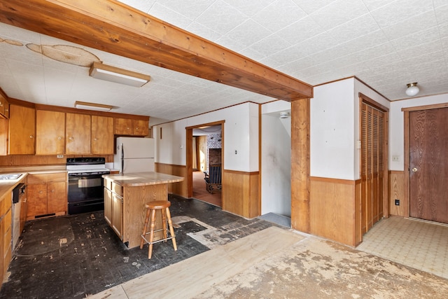 kitchen featuring white appliances, dark wood-type flooring, a center island, a breakfast bar area, and wood walls