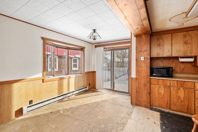 interior space with a baseboard radiator and wooden walls