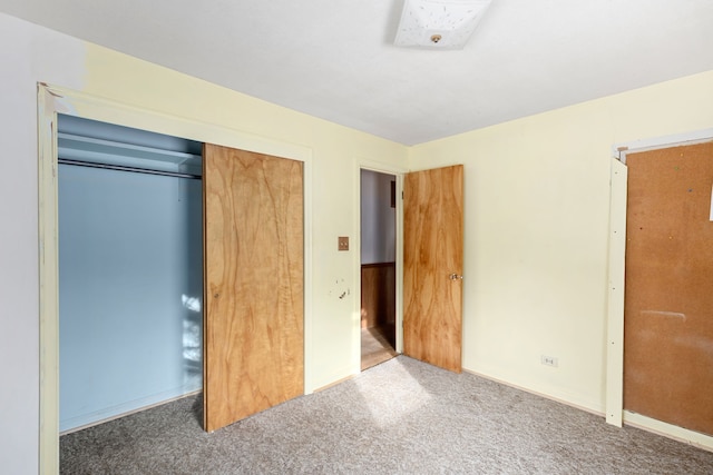 unfurnished bedroom featuring carpet floors and a closet