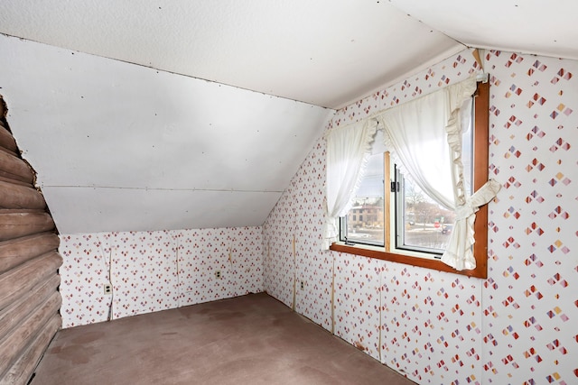 additional living space featuring vaulted ceiling