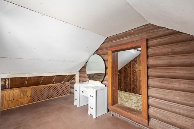 additional living space with wooden walls and lofted ceiling