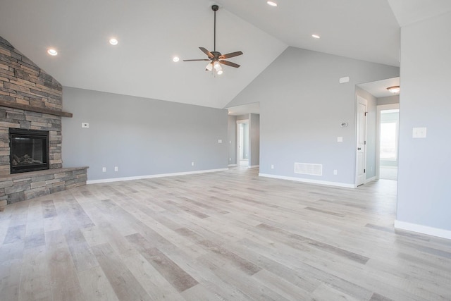 unfurnished living room featuring light hardwood / wood-style floors, ceiling fan, high vaulted ceiling, and a fireplace