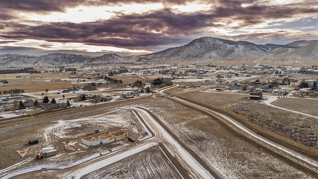 aerial view at dusk featuring a mountain view