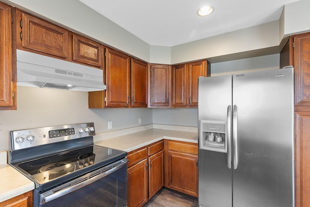 kitchen with stainless steel appliances and hardwood / wood-style flooring