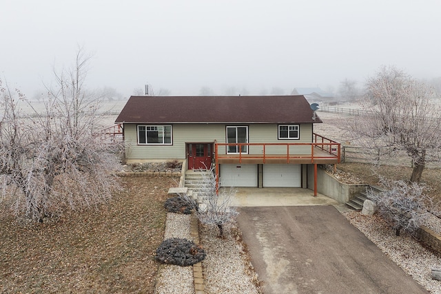 view of front of house with a garage and a wooden deck