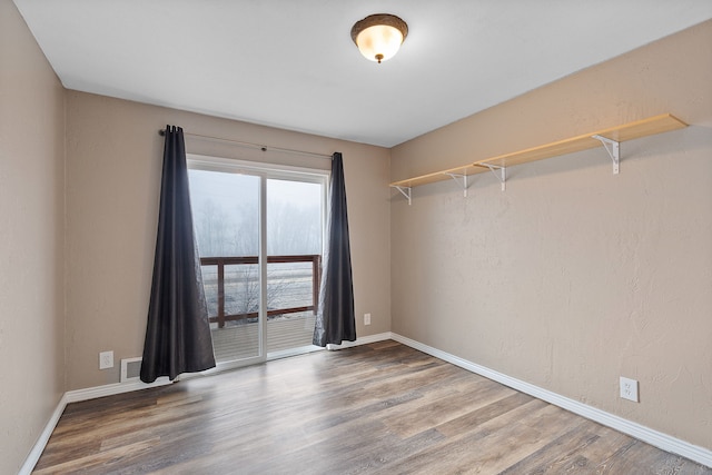 empty room with hardwood / wood-style flooring