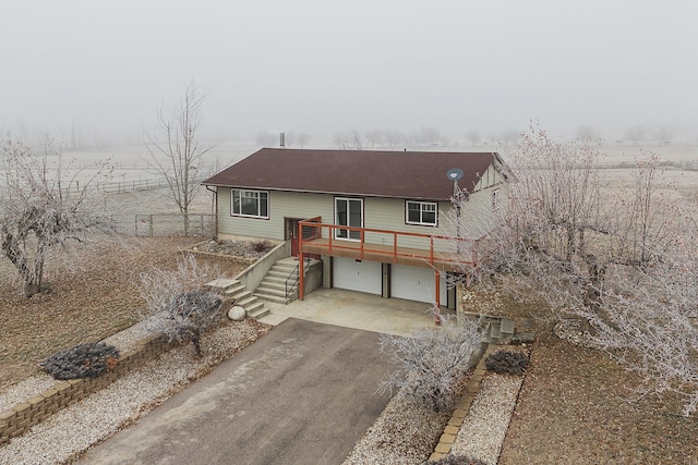 view of front facade with a garage and a deck