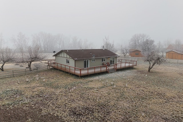 rear view of property featuring a wooden deck