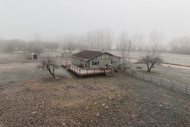 exterior space featuring a rural view and a wooden deck