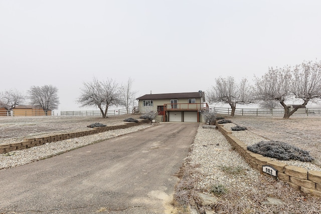 view of front of house featuring a garage and a deck