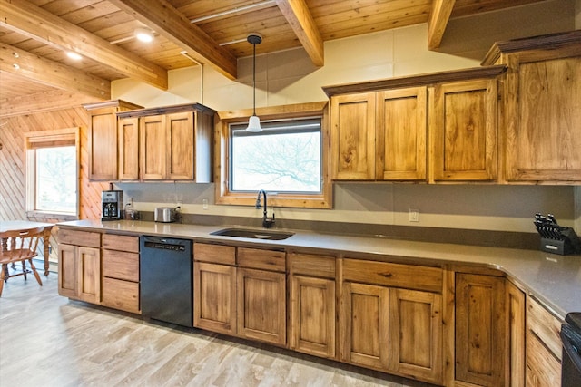 kitchen featuring beamed ceiling, black dishwasher, plenty of natural light, and sink