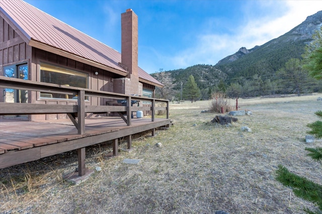 view of yard with a deck with mountain view