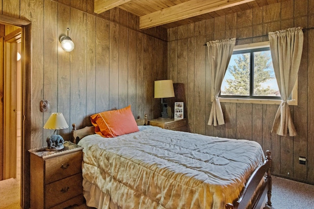 carpeted bedroom featuring wood walls, beam ceiling, and wooden ceiling