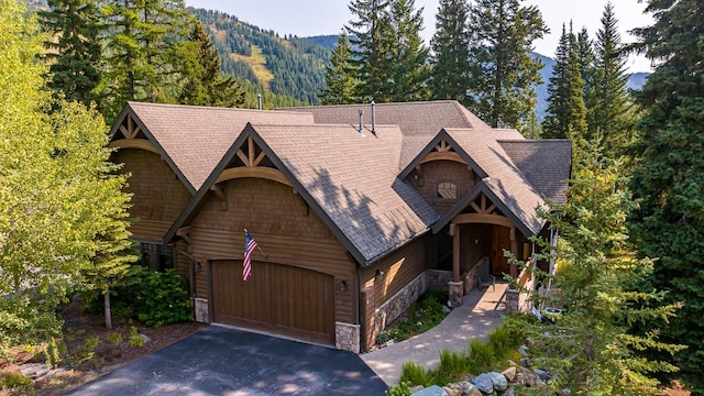 view of front of home with a mountain view and a garage