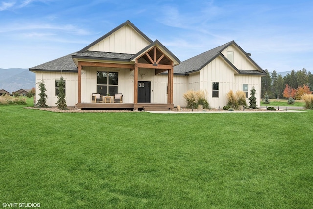 505 Sweetgrass Ranch Rd, Kalispell, MT 59901 - modern farmhouse style home featuring board and batten siding, a front lawn, a shingled roof, and covered porch