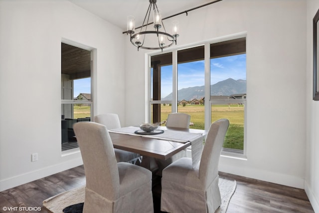 dining room featuring a mountain view, dark hardwood / wood-style floors, and a wealth of natural light