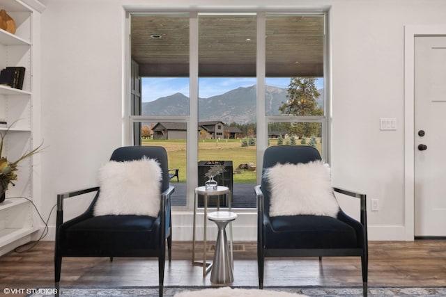 living area with a mountain view and hardwood / wood-style floors