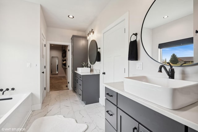 505 Sweetgrass Ranch Rd, Kalispell, MT 59901 - full bath with marble look tile flooring, two vanities, a tub, and recessed lighting