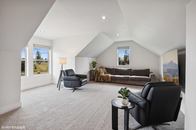 living room featuring light carpet, plenty of natural light, and lofted ceiling