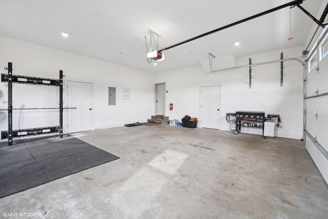 garage featuring electric panel and a garage door opener