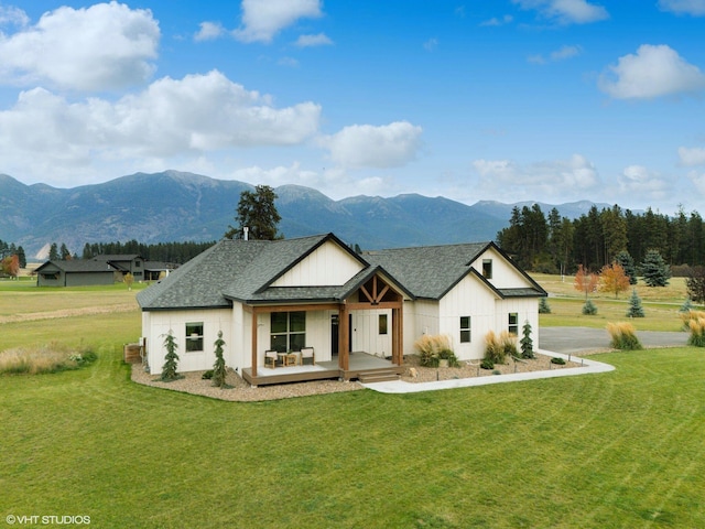 modern farmhouse style home featuring a mountain view and a front lawn