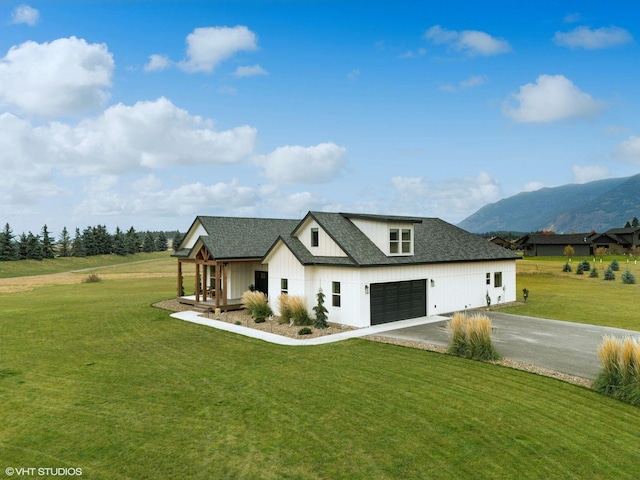 505 Sweetgrass Ranch Rd, Kalispell, MT 59901 - modern farmhouse style home with driveway, roof with shingles, a front yard, and a mountain view