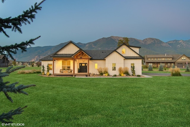 modern farmhouse style home with a mountain view and a front yard