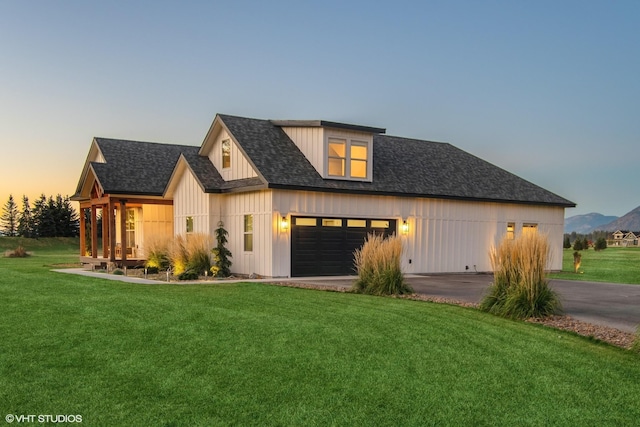 modern inspired farmhouse with a yard and a garage