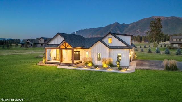 view of front of property with a mountain view and a yard