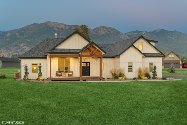 view of front facade featuring a mountain view, a porch, and a front lawn