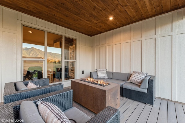 wooden deck with a mountain view and a fire pit