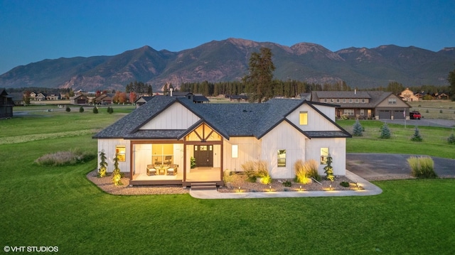 505 Sweetgrass Ranch Rd, Kalispell, MT 59901 - rear view of property with a lawn, a mountain view, and board and batten siding