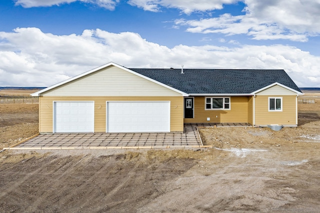 ranch-style home featuring a garage