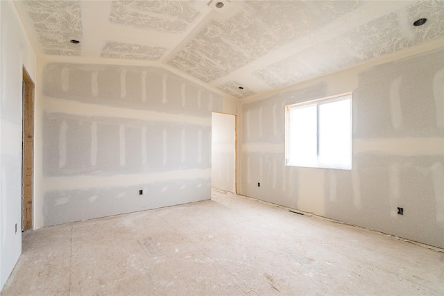 spare room with lofted ceiling