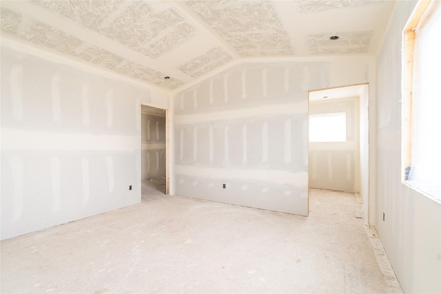 empty room with vaulted ceiling