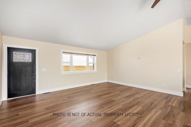 unfurnished living room featuring hardwood / wood-style flooring and ceiling fan