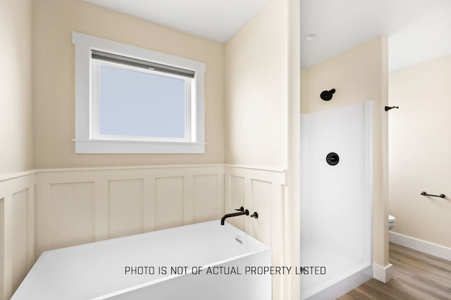 bathroom with a shower, wood-type flooring, and toilet