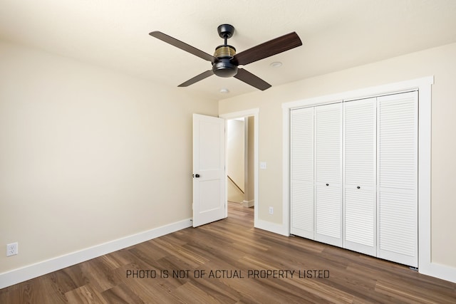 unfurnished bedroom with ceiling fan, a closet, and hardwood / wood-style flooring