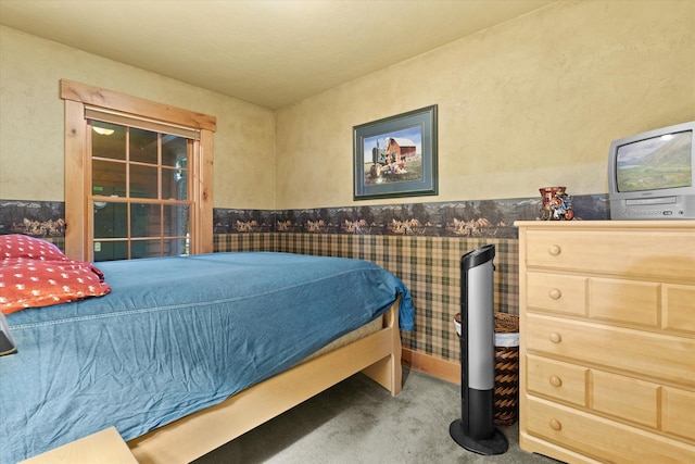 carpeted bedroom featuring a wainscoted wall