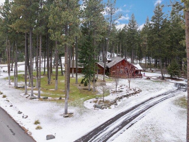 snow covered house with a wooden deck