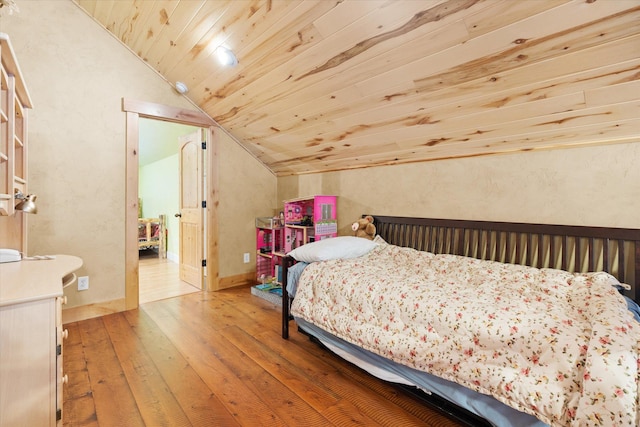 bedroom with lofted ceiling, wooden ceiling, and wood-type flooring